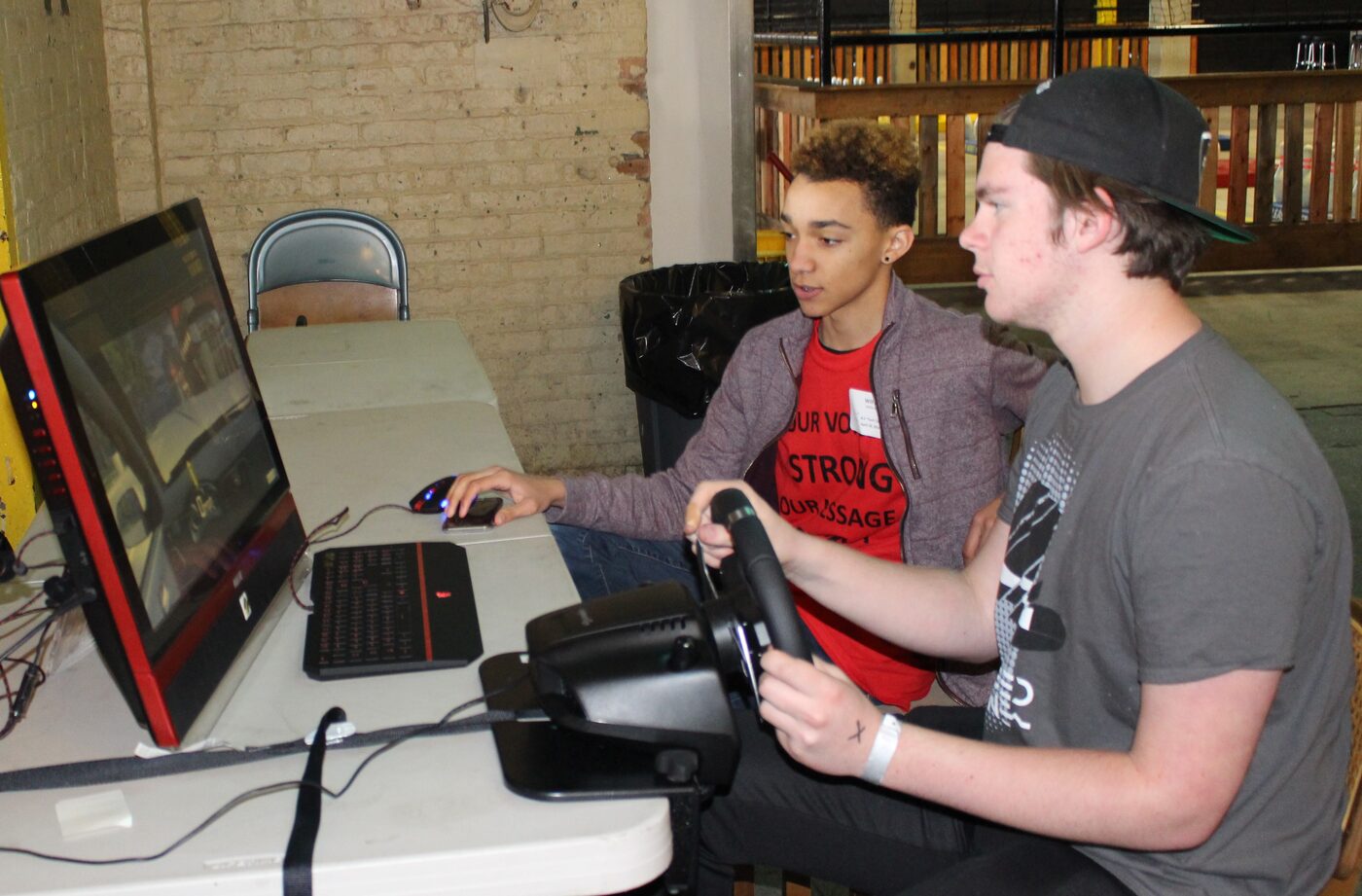 Students using the AAA-sponsored driving simulator at an SLS training